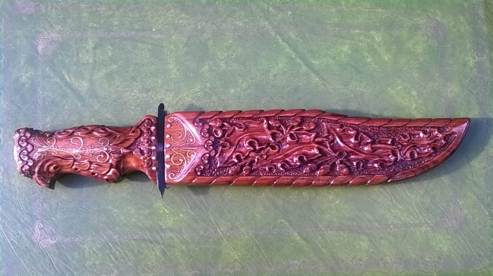 Knife carved in walnut with floral motif and silver wire decoration at the rear (front view)