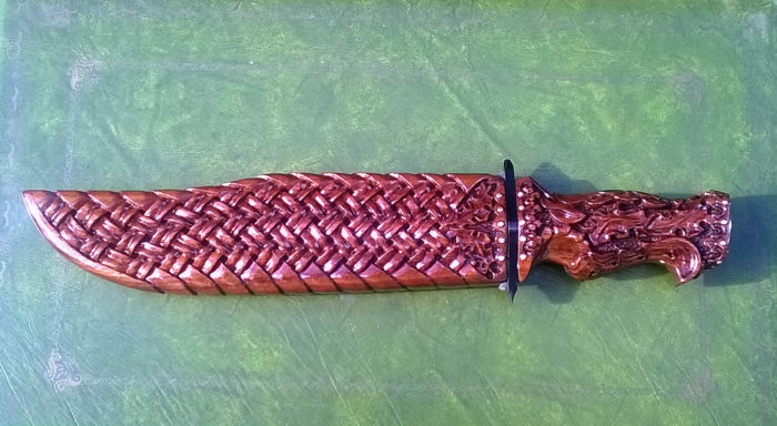 Knife carved in walnut with floral motif and silver wire decoration at the rear (side view)